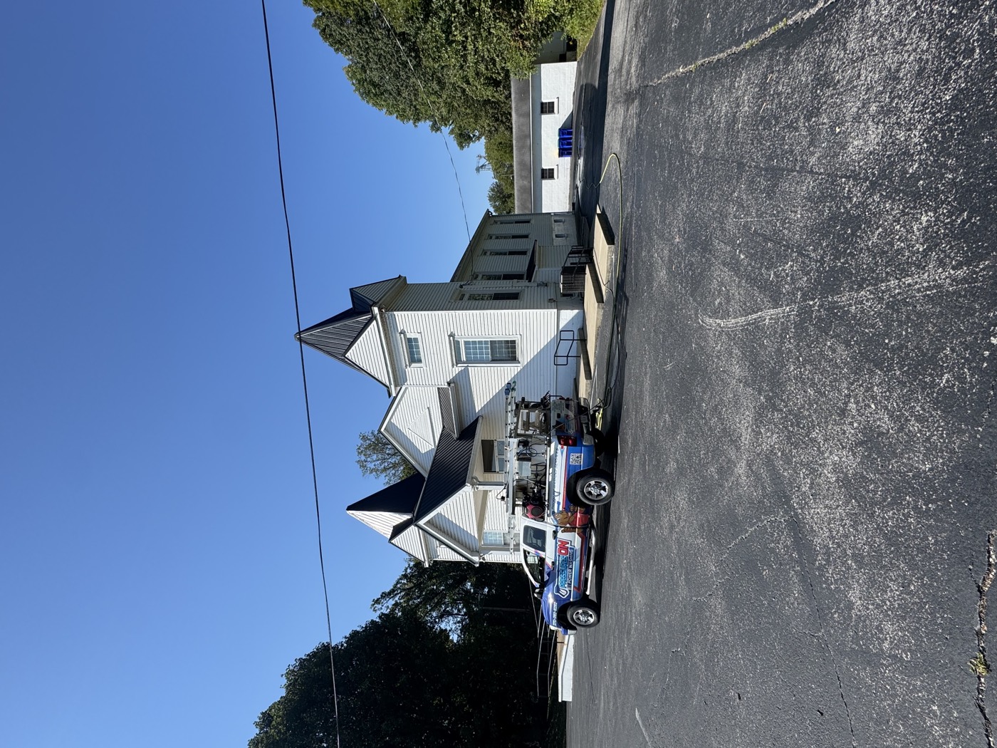 A white church cleaned by Pressures ON, with the work truck in the parking lot