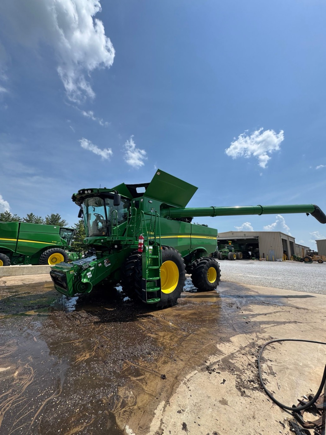 A John Deere combine being washed on a wash pad
