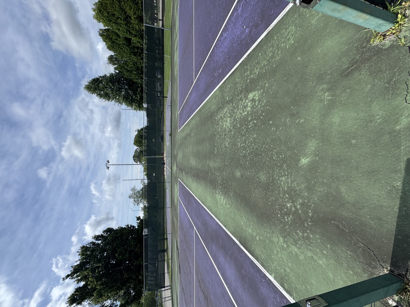 Tennis court before washing, faded and dirty