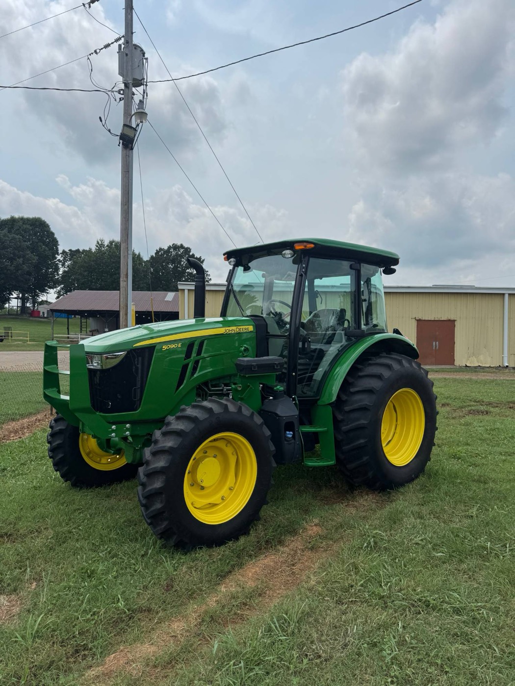 A clean John Deere 5090E cab tractor
