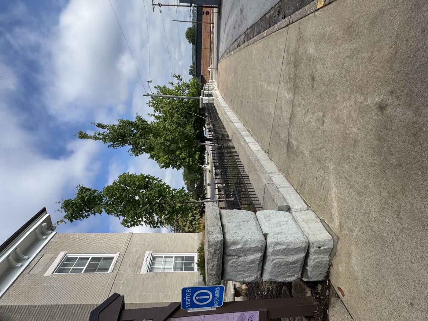 A freshly cleaned concrete sidewalk along a downtown building